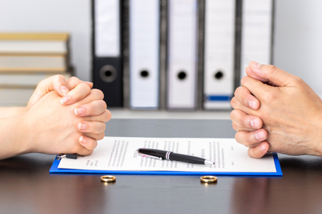 Divorce papers and wedding rings on a table